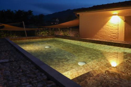 a swimming pool in a backyard at night at Riva Quartarola in Modigliana