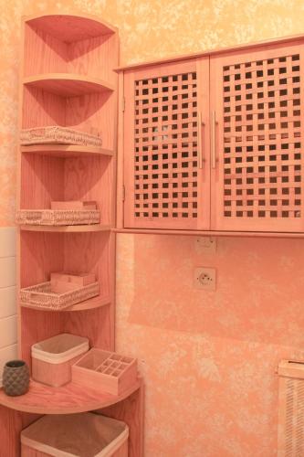 a wooden cabinet in a room with shelves at Le château in Blanquefort