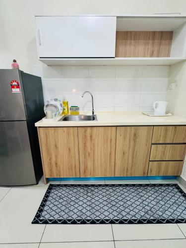 a kitchen with a sink and a refrigerator at CHEAPEST PROMO Private Modern King Suites above Mesamall Nilai, 3 Km to USIM in Nilai