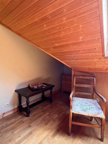 a wooden room with a table and a chair at Le Chalet Charmette vue montagnes in Villard-de-Lans