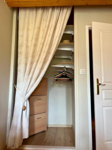 a curtain in a room with a closet at Le Chalet Charmette vue montagnes in Villard-de-Lans