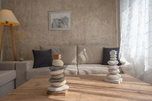 a living room with a table with rocks on it at Valea Villa in Agios Prokopios