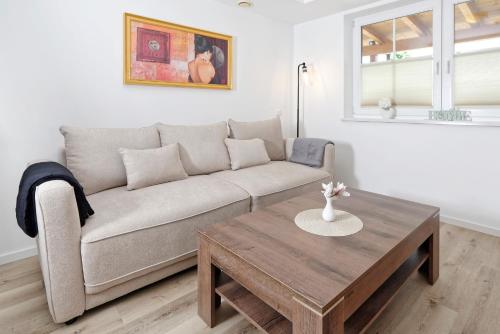 a living room with a couch and a coffee table at Ortnerhof - Ihr Zuhause am Fuße der Alpen in Ruhpolding
