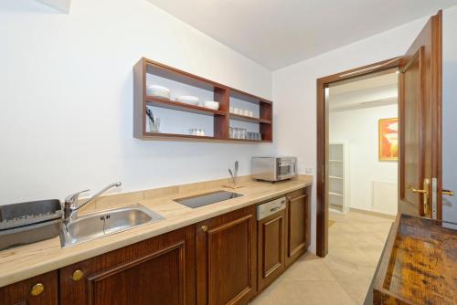 a kitchen with a sink and a microwave at Ortnerhof - Ihr Zuhause am Fuße der Alpen in Ruhpolding