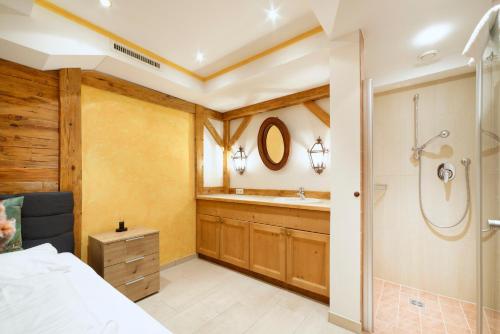 a bedroom with a bathroom with a shower and a sink at Ortnerhof - Ihr Zuhause am Fuße der Alpen in Ruhpolding
