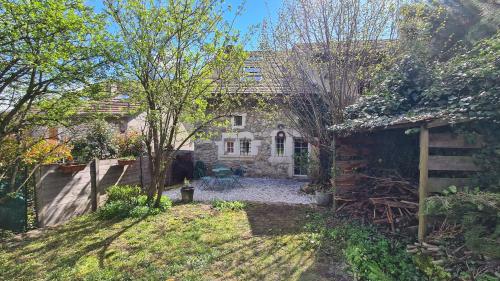 an old stone house with a garden in front of it at Charming village house in Chevrier France, near Geneva in Chevrier
