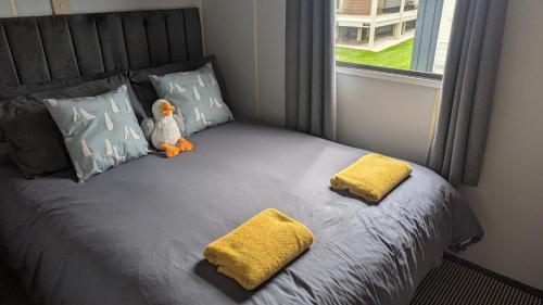 a small bed with a stuffed animal sitting on it at Seagulls Rest - Dog Friendly - Close to the Beach in Anderby