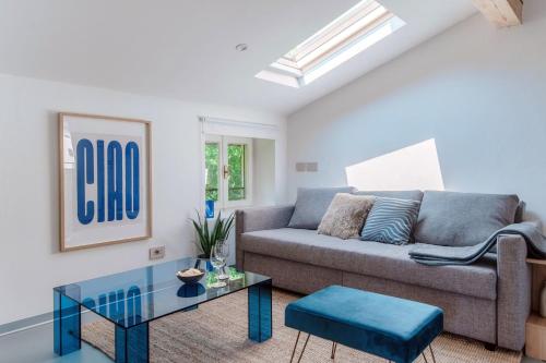 a living room with a couch and a glass table at Luce & Olive - by MyHomeInComo in Acquaseria