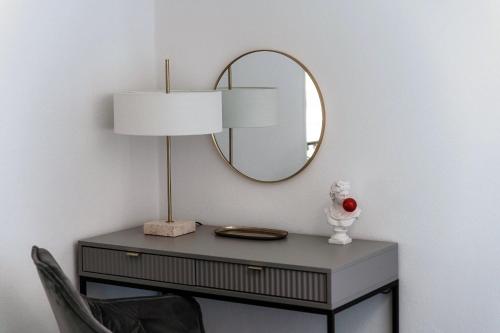 a dressing table with a mirror and a chair at Luce & Olive - by MyHomeInComo in Acquaseria