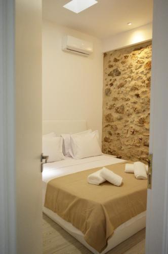 a bedroom with a bed with two towels on it at Faragnanti #2 in Gythio