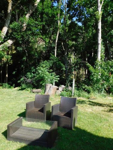 two chairs sitting in the grass in a park at Apartment in Blankenstein 3167 in Blankenstein