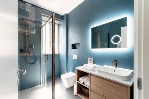 a bathroom with a sink and a shower at Luce & Olive - by MyHomeInComo in Acquaseria