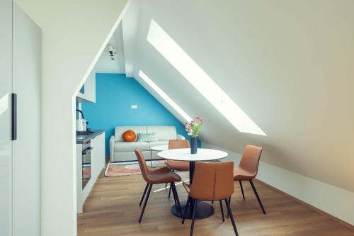 a room with a table and chairs and a couch at LeonArt Living 61 in Graz