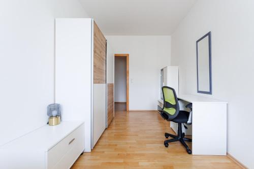 a white office with a chair and a desk at ShalalaLiving Apartments Mariazell in Mariazell