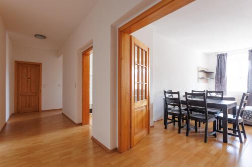 a dining room with a black table and chairs at ShalalaLiving Apartments Mariazell in Mariazell