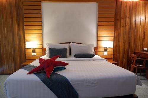 a bedroom with a large bed with a red starfish on it at Phi Phi Villa Resort in Phi Phi Don