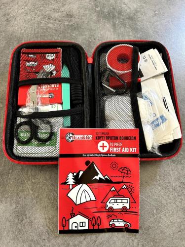 a suitcase with a first aid kit and a book at Sunlit Serenity in Paphos in Paphos