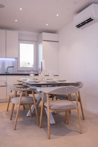 a dining room with a table and some chairs at Penthouse Alure in Split