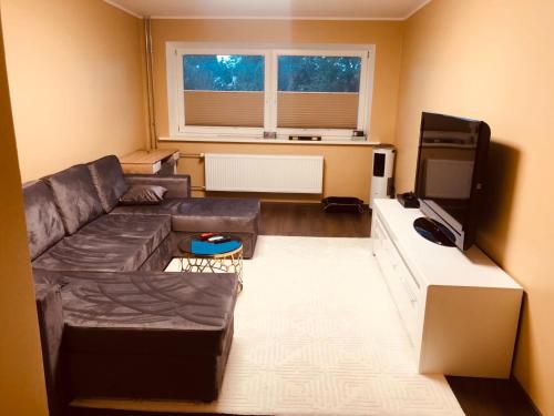 a living room with a couch and a flat screen tv at Rummu Summer in Rummu
