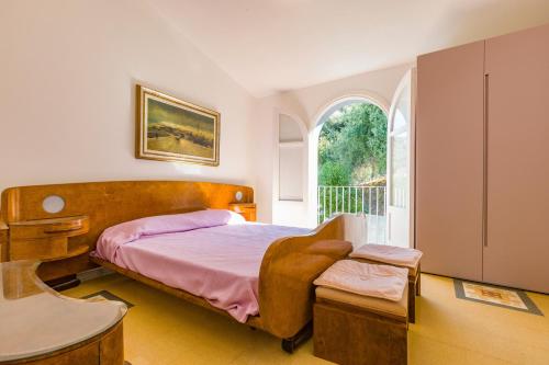 a bedroom with a bed and a window at Villa Tina in Patti