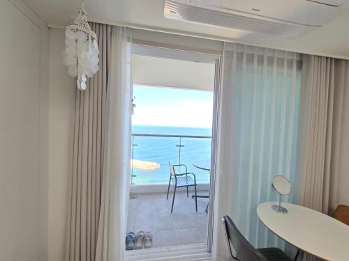 a dining room with a view of the ocean at Sokcho Summitbay 1708 "Ocean View" in Sokcho