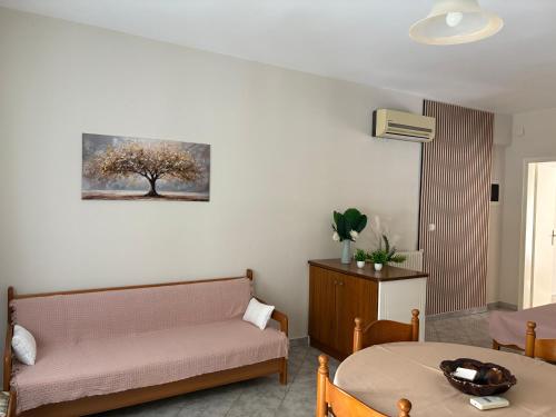 a living room with a couch and a table at Villa Soula in Nea Vrasna