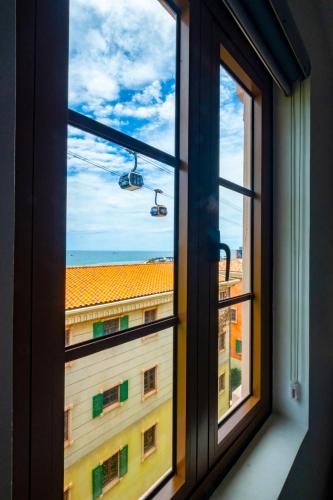 a window with a view of a building at Jana Hotel & Apartment - Firework & Aquatopia Water Park in Phu Quoc