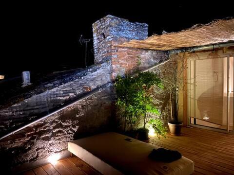 a bench sitting on a porch of a building at night at Designer townhouse with 2 stunning terraces in Lafrançaise