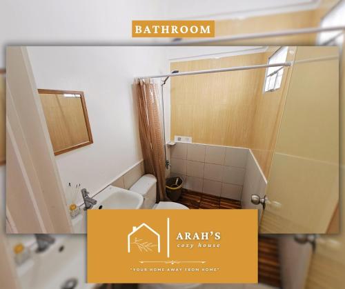 a bathroom with a shower and a toilet in a room at Arah Cozy House in Dasmariñas