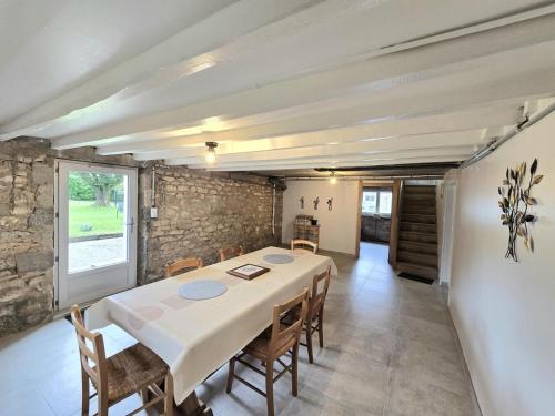 a dining room with a white table and chairs at Chez louise in Rouffignac Saint-Cernin