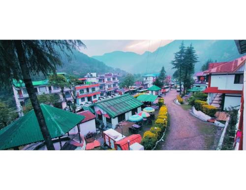 a view of a town with buildings and a street at Hotel महिमा रेसॉर्ट in Uttarkāshi