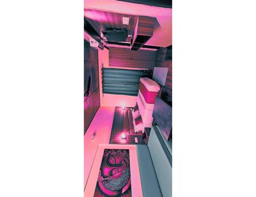 an overhead view of a room with pink lighting at Hotel महिमा रेसॉर्ट in Uttarkāshi