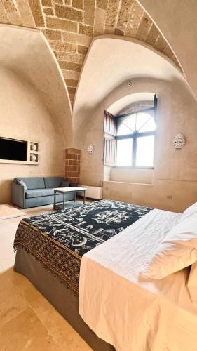 a large bedroom with a large bed and a window at Borgo Don Ciccio in Felline