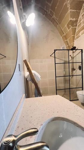a bathroom with a counter and a sink at Borgo Don Ciccio in Felline