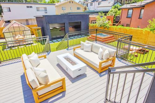 a balcony with two chairs and a couch on it at Modern Villa w jacuzzi sauna&garden in Los Angeles
