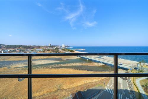 a view of the ocean from a balcony at DIAMER Hotel Sokcho by AankStay in Yangyang