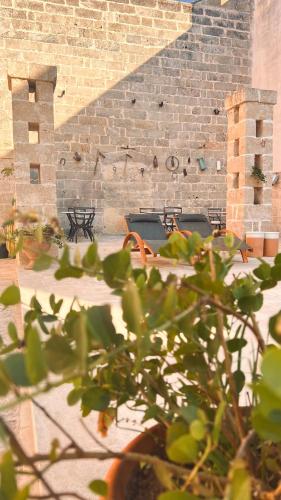 a brick building with a bench and a brick wall at Borgo Don Ciccio in Felline