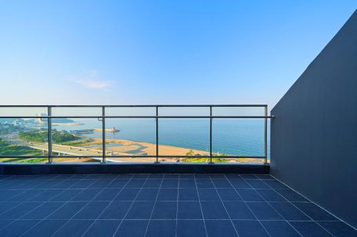 a view of the ocean from the balcony of a building at DIAMER Hotel Sokcho by AankStay in Yangyang