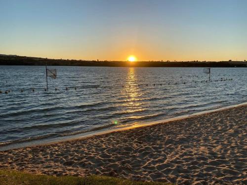 a beach with ducks in the water at sunset at Apartamento tranquilo y luminoso in Arcos de la Frontera
