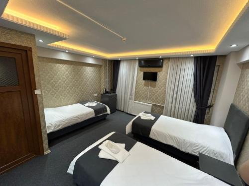 Postel nebo postele na pokoji v ubytování Grand Sezgin Hotel
