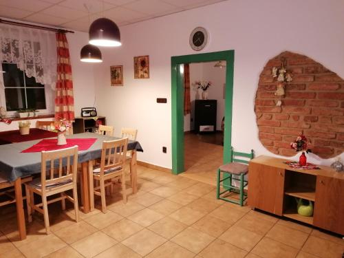 a kitchen and dining room with a table and chairs at chalupa Vadčice in Dehtáře
