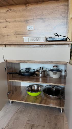 a kitchen with pots and pans on a shelf at SouthLux3 in Tossor