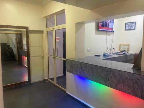 a room with a counter with a rainbow light at Beamgate Hotels & Apartments, Abak Rd, Uyo in Uyo
