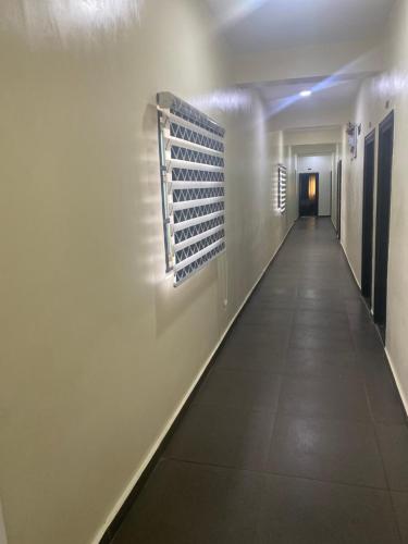 a long hallway with a bunch of wine racks on the wall at Beamgate Hotels & Apartments, Abak Rd, Uyo in Uyo