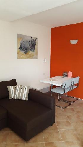 a living room with a couch and a table at Agriturismo OlivArancio in Leivi