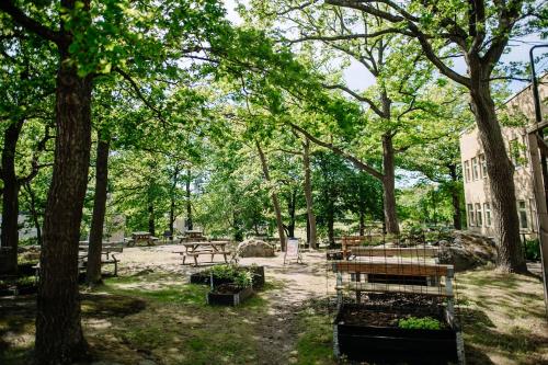 a park with tables and benches and trees at Second Home Apartments Asplund in Solna