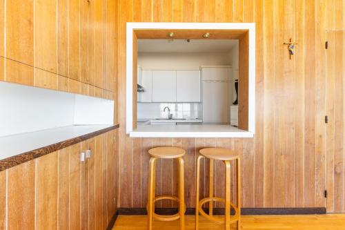Dos taburetes en una cocina con espejo. en Clapotis A 0701 G, en Oostduinkerke