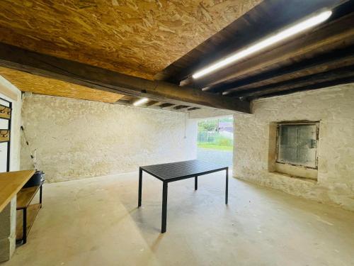 a room with a black table in the middle of it at Maison des Mottes - Cour et garage in Asnières-la-Giraud