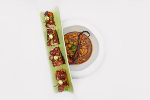 two plates of food and a bowl of soup at Agroturismo Santa Mariana in Alaior