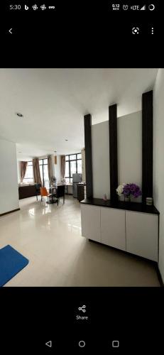 a living room with a large room with a couch and a table at Lake view homestay in Serdang